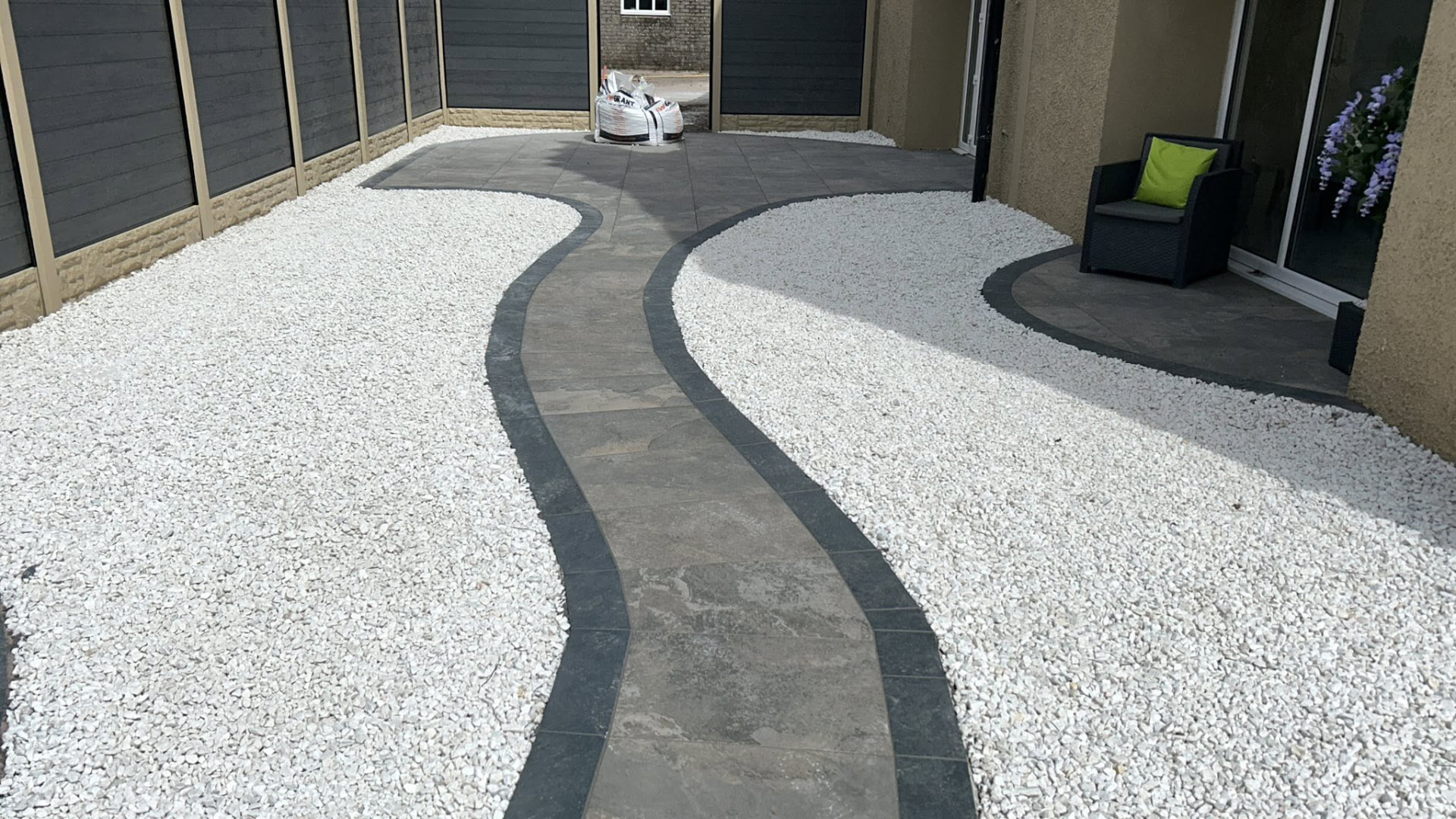 Curved paved garden path with white decorative stone